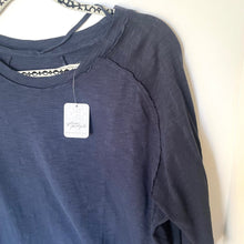 Load image into Gallery viewer, Blue shirt with a tag on a white background