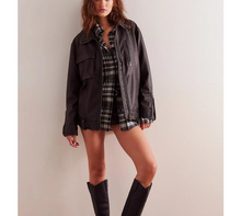 Load image into Gallery viewer, Person wearing a black jacket, plaid shirt, and knee-high boots against a plain background