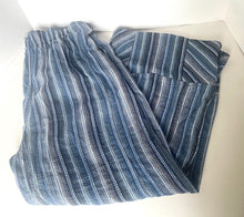 Load image into Gallery viewer, Folded blue and white striped fabric on a light gray background