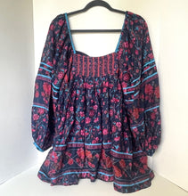 Load image into Gallery viewer, Floral patterned dress on a hanger against a white background