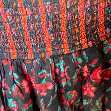 Load image into Gallery viewer, Close-up of a colorful floral dress with a pattern of red, black, and green.