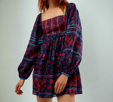 Load image into Gallery viewer, Woman wearing a colorful patterned dress on a plain background