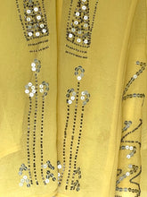 Load image into Gallery viewer, A close-up of a yellow fabric garment featuring detailed silver and white sequin embroidery in vertical floral and geometric patterns.