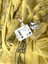 Load image into Gallery viewer, A close-up of a yellow embroidered fabric garment with metallic gold and silver thread detailing, featuring a white product tag attached.