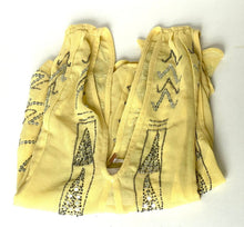 Load image into Gallery viewer, A pale yellow cotton bandana scarf with black geometric and dotted patterns, folded on a white background.