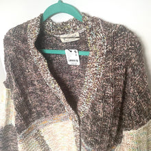 Load image into Gallery viewer, Patterned sweater on a hanger with a visible tag against a neutral background