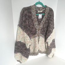 Load image into Gallery viewer, Knitted cardigan on a hanger against a white background