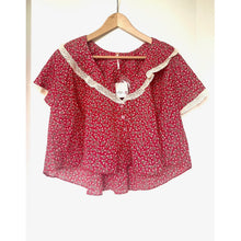 Load image into Gallery viewer, Red floral blouse with lace trim on a hanger against a white background