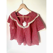 Load image into Gallery viewer, Red floral blouse with lace trim on a hanger against a white background