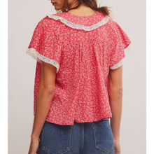 Load image into Gallery viewer, Woman wearing a red floral blouse with lace trim on a plain background