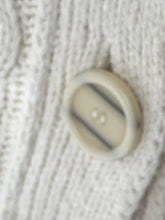 Load image into Gallery viewer, Close-up of a cream-colored button on a white ribbed knit fabric.
