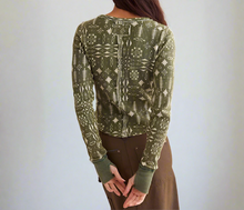 Load image into Gallery viewer, Green patterned long-sleeve top worn by a person on a plain background