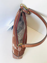 Load image into Gallery viewer, A brown and white cowhide shoulder bag with a brown leather strap, gold-tone hardware, and a zippered opening, shown on a white background.