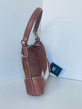 Load image into Gallery viewer, A brown leather and cowhide handbag with a block heel, shown from the side against a white background with a brand tag attached.