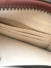 Load image into Gallery viewer, Close-up of a beige canvas zippered pouch or wallet interior with a reddish-brown zipper edge.