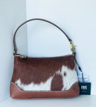 Load image into Gallery viewer, A Frye handbag made of brown and white cowhide with smooth brown leather trim and handle, shown on a white background with its brand tag visible.