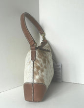Load image into Gallery viewer, A small shoulder bag with a white and brown cowhide pattern body, brown leather trim, and a brown top handle, standing in a white corner.