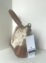 Load image into Gallery viewer, A small handbag with a brown leather handle and trim, combined with a cowhide-patterned body, shown with a white product tag that reads Comfortable Wristlet.