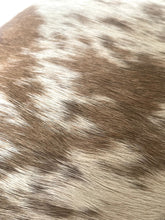 Load image into Gallery viewer, Close-up of a brown and white spotted fur texture, likely a cowhide or mottled animal hide material.