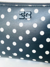 Load image into Gallery viewer, Polka dot patterned pouch with a brand logo on a light gray background
