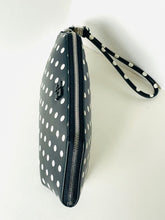 Load image into Gallery viewer, Black wristlet with white polka dots on a light gray background