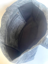 Load image into Gallery viewer, Top-down view of a gray waxed canvas tote bag showing its black interior lining, zipper pocket, and fabric texture.