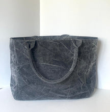 Load image into Gallery viewer, A large charcoal gray waxed canvas tote bag with dual top handles, photographed against a plain off-white background.