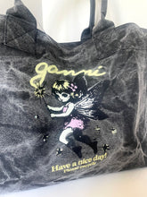 Load image into Gallery viewer, A dark gray mineral-wash canvas tote bag featuring a graphic of a fairy holding a sparkler, with the text 'Janni' in yellow and 'Have a nice day! Please recycle' printed below.