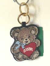 Load image into Gallery viewer, A teddy bear-shaped keychain featuring a brown embroidered bear holding a red heart with the word 'GANNY' in white, attached to gold-tone rings and a metal key ring.