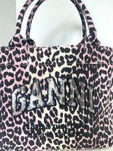 Load image into Gallery viewer, Pink leopard print handbag with 'Ganni' branding on a white background