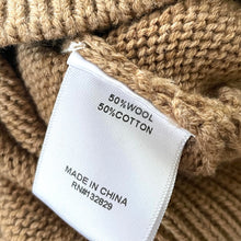 Load image into Gallery viewer, Close-up of a label on a knitted item indicating 50% wool and 50% cotton, with 'Made in China' text.