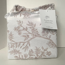 Load image into Gallery viewer, Floral-patterned fabric with a tag on a white background
