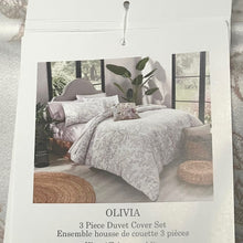 Load image into Gallery viewer, Advertisement for Olivia 3-piece duvet cover set with bedding and decor on a bed.