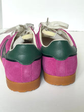 Load image into Gallery viewer, A pair of low-top sneakers shown from the back, featuring bright pink suede uppers, dark green leather heel panels, tan gum soles, and off-white laces.