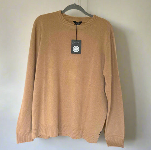 Brown sweater on a hanger with a visible brand tag against a white background