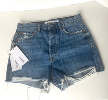 Load image into Gallery viewer, Blue denim shorts with a tag on a white background