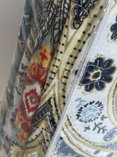 Load image into Gallery viewer, Stack of patterned fabric swatches in a clear plastic bag