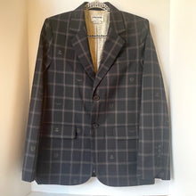 Load image into Gallery viewer, Woman wearing a black and gray checkered blazer over a black top and pants on a white background