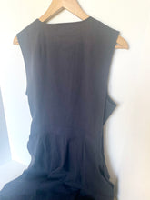 Load image into Gallery viewer, A sleeveless dark charcoal gray dress hanging on a light wood hanger against a plain white wall.