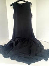 Load image into Gallery viewer, A black sleeveless dress with a gathered, voluminous skirt, hanging on a black hanger against a plain white background.