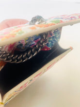 Load image into Gallery viewer, Colorful handbag with floral pattern and chain detail on a light background