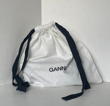 Load image into Gallery viewer, White drawstring bag with black straps on a white background