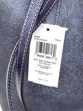 Load image into Gallery viewer, Close-up of a textured navy blue leather bag with a white retail hangtag attached, showing printed product information and a barcode.