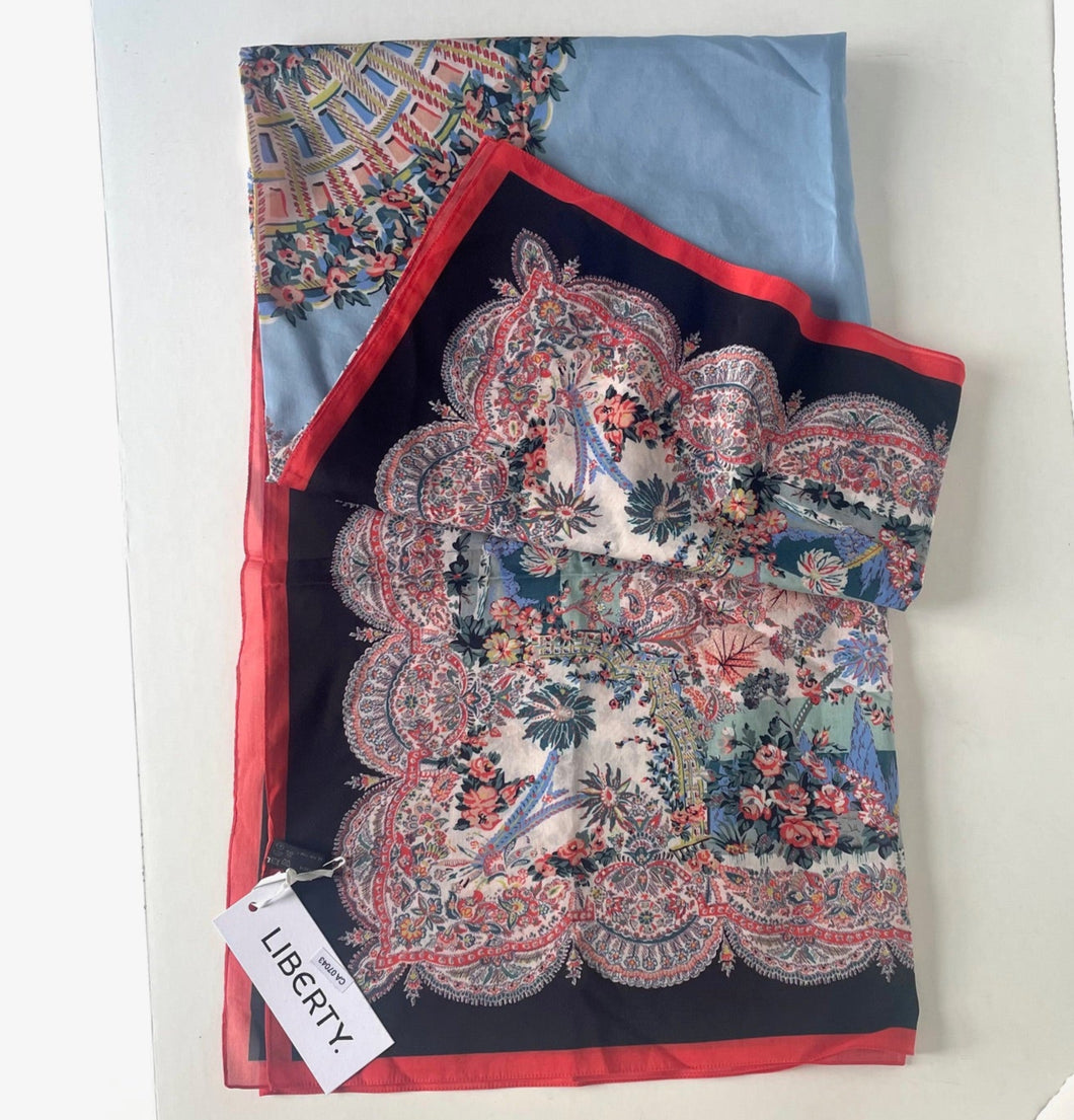 Colorful patterned scarf with a Liberty label on a white background
