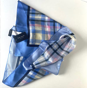 Blue plaid scarf with a visible brand tag on a white background