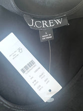 Load image into Gallery viewer, J.Crew label on a black garment with a tag showing size and material details.