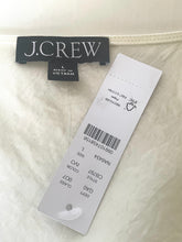 Load image into Gallery viewer, J.Crew label on a garment with a white background