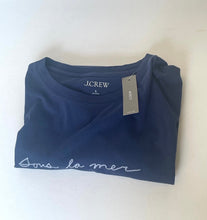 Load image into Gallery viewer, Folded navy blue J.Crew t-shirt with 'sous la mer' text on a white background