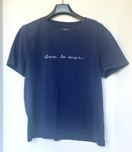Load image into Gallery viewer, Navy blue t-shirt with white text on a hanger against a white background