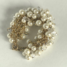 Load image into Gallery viewer, Bracelet with pearls and gold chain on a light gray background